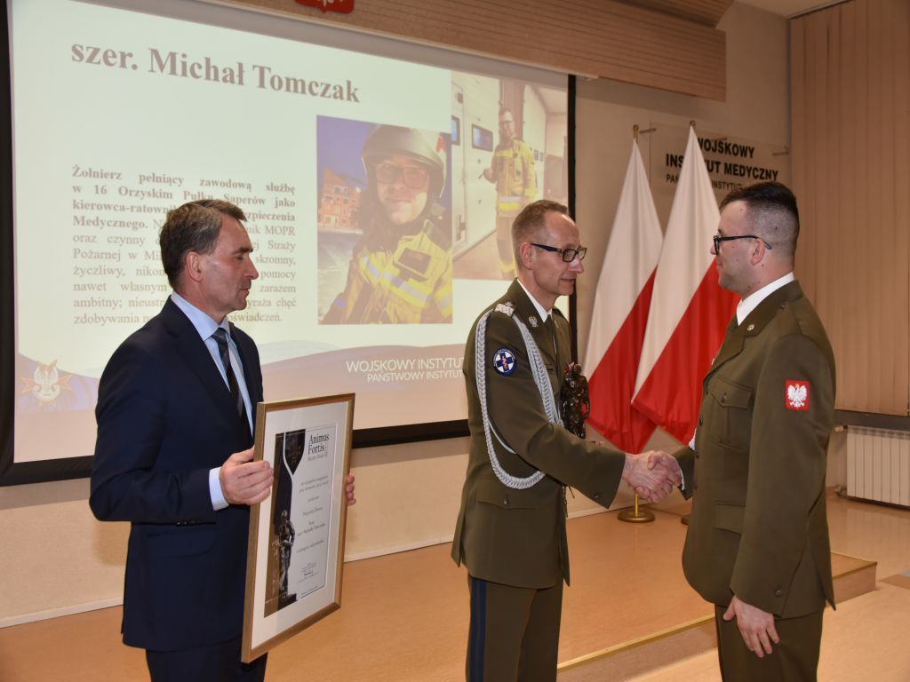 Michał Tomczak odbiera nagrodę Animus Fortis z rąk dyrektora Wojskowego Instytutu Medycznego