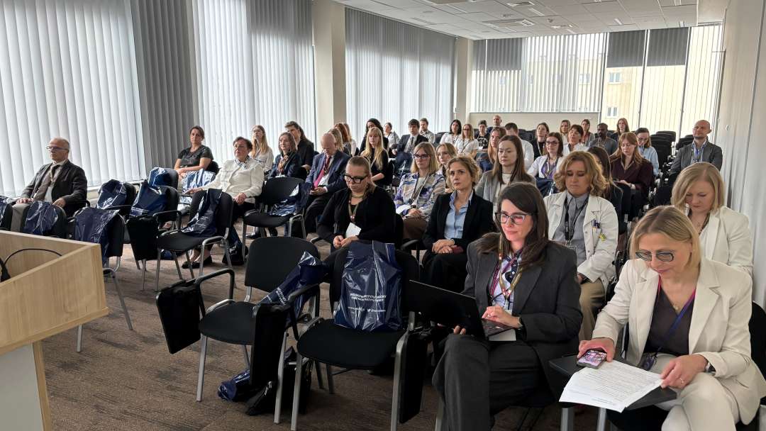 Siedzący słuchacze i prelegenci podczas konferencji na sali wykładowej WIM.