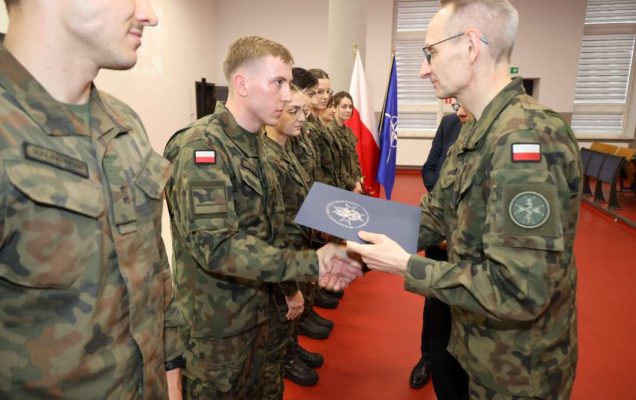Dyrektor WIM gratuluje wyróżnionym lekarzom ubranym w mundury wojskowe.